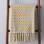Knitted Couch Blanket with Tassels — product in use