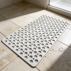 White Secure Shower Mat on travertine tile at the edge of a shower screen