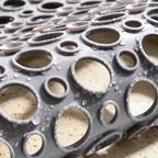 Close-up of the Secure Shower Mat drainage holes and suction cups with water draining through