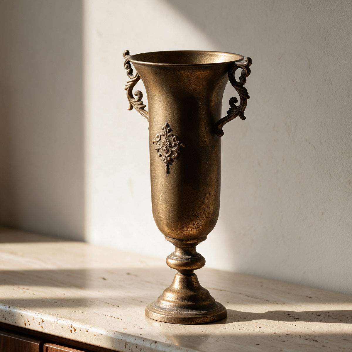 Royal Antique Gold Vase standing empty on a travertine sideboard, read as sculpture