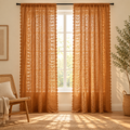 Amber Glow Boho Crochet Curtain, two panels at a window with sunlight filtering through the crochet