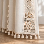 Boho Linen Curtain hem detail with cream cotton tassels and crochet lace above an oak floor