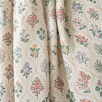 Close-up of Wildflower Lace Ruffle Curtain fabric: multicolour botanical sprigs in a fine trellis on cream linen-look fabric