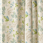 Close-up of Wildflower Veil Curtain fabric: blue, teal and green botanical leaves on cream linen-look fabric