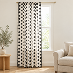 Chic Polka Dot Tassel Window Curtain in black and off-white, hanging on a brass rod in a bright living room