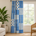 Blue geometric dots patchwork curtain, cobalt on cream with tassel edge, hanging floor length in a bright living room