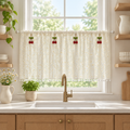 Daisy Breeze Cabinet Curtain in cream with white daisies and pom-pom hem, hung cafe-style across a kitchen window