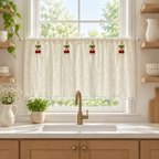 Daisy Breeze Cabinet Curtain in cream with white daisies and pom-pom hem, hung cafe-style across a kitchen window