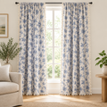 Blue rose floral curtains, navy roses on cream linen-look fabric with tassel edge, framing a living room window
