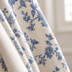 Close-up of navy blue rose print on cream linen-look curtain fabric