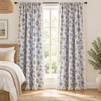 Blue rose floral curtains framing a bright bedroom window