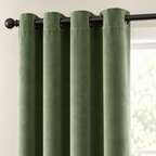 Close-up of the grommet top on the grass green velvet curtain threaded on a black rod