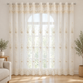 Elyvia Embroidered Classic Sheer Lace Curtain in white with champagne embroidery, grommet top, across a tall window in a bright living room