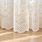 Close-up of the scalloped embroidered lace hem on the Elyvia sheer curtain
