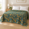 Jacquard Floral Ginkgo Leaves Reversible Coverlet – spread over a made bed in a bright bedroom with plain white pillows