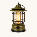 Retro Glow vintage LED lantern in Army Green, switched on with a warm glow