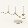 Tri Iron Twisted Candle Holder in Cream Waves with three lit white taper candles