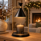 Onyx Brass candle warmer lamp on a console table by a fireplace with holiday garland