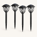 Four black solar garden stake lanterns with solar panels on top
