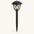 Solar garden stake lantern in black with rippled glass-look panels, glowing warm white