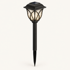 Solar garden stake lantern in black with rippled glass-look panels, glowing warm white