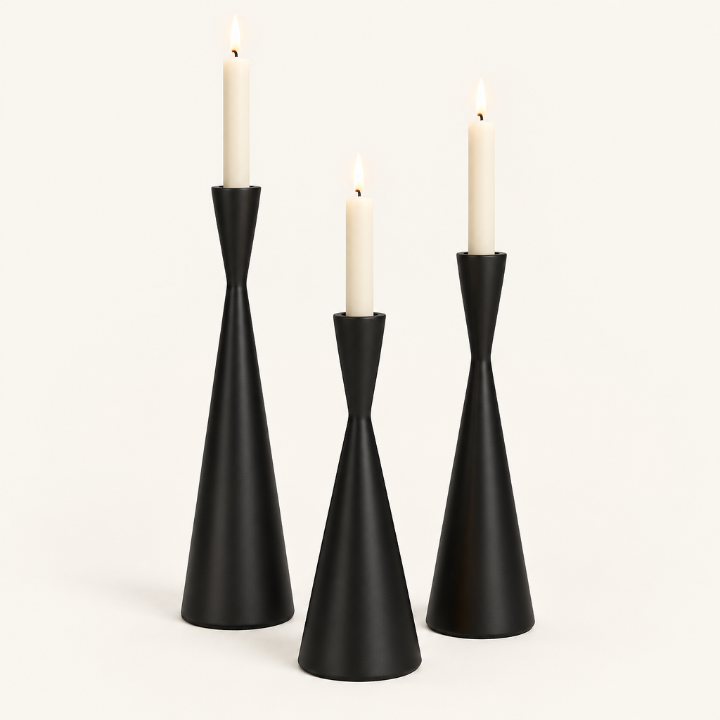 Set of 3 matte black hourglass taper candlesticks in Obsidian Elegance with lit ivory candles