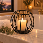 Sculptural Black wire candle holder on a bathtub ledge at dusk
