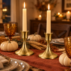 Antique Gold taper candlesticks on a Thanksgiving dinner table with pumpkins and wheat