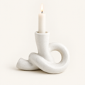 Knot ceramic candle holder, Short, cream speckled, with a lit taper candle