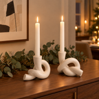 Knot ceramic candle holders with eucalyptus garland on a dining room sideboard
