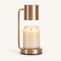 Calla candle warmer lamp in rose gold with cylinder shade warming a jar candle