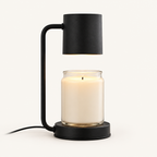 Calla candle warmer lamp in black with cylinder shade warming a jar candle
