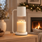 White Calla candle warmer lamp on a console table by a fireplace with holiday garland