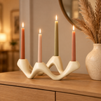 White Cosmic Ripple candelabra with autumn-toned tapers on an oak console table