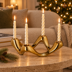 Gold Cosmic Ripple candelabra on a travertine coffee table in a holiday living room