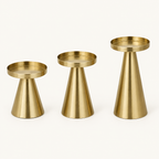 Three gold cone pillar candle holders shown empty, with round rimmed candle trays