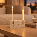 Travertine taper candle holder on an oak coffee table in a neutral living room at dusk