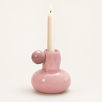 Celestial Nordic glass candle holder in pink with a lit taper candle