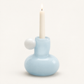 Celestial Nordic glass candle holder in powder blue with white glass ball, holding a lit taper candle