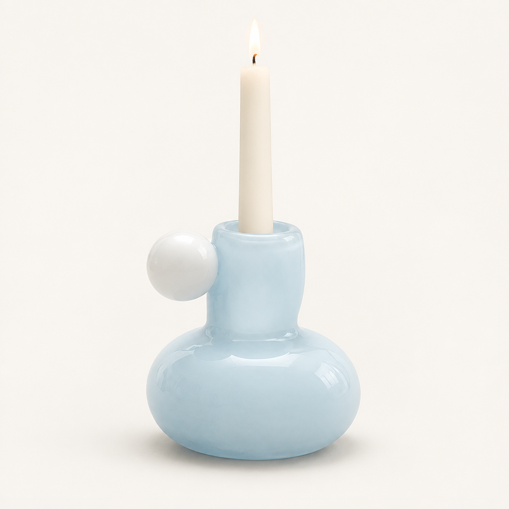 Celestial Nordic glass candle holder in powder blue with white glass ball, holding a lit taper candle