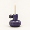 Celestial Nordic glass candle holder in purple with a lit taper candle