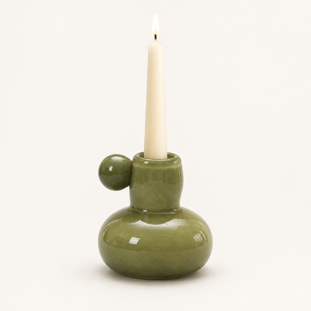 Celestial Nordic glass candle holder in olive green with a lit taper candle
