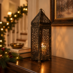 Long Moroccan lantern on a wooden entryway console decorated for the holidays