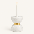 Small Colette marble hourglass candle holder with a lit white taper candle