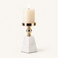 Pyramid marble and gold pillar candle holder, size M, with a lit ivory candle on a warm off-white background