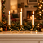 Gold iron taper candelabra lit on a holiday mantel with pine garland