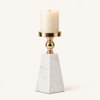 Pyramid marble and gold pillar candle holder, size L, with a lit ivory candle on a warm off-white background