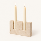 Timeless Glow travertine candle stand, Polished finish, with two lit ivory taper candles