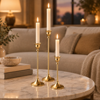 Gold taper candlesticks on a marble coffee table in a cosy living room