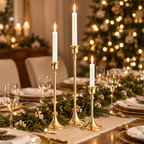 Gold taper candlesticks on a holiday dinner table with a Christmas tree behind